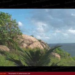 Land on the ocean. With huge rocks.